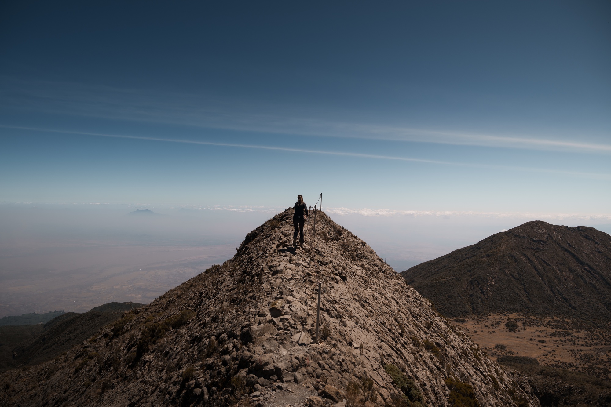 Hiker walking on the top of mount meru in tanzania, africa